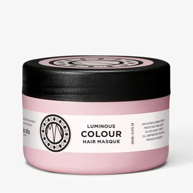 Pink hair mask jar with black lid on a white background