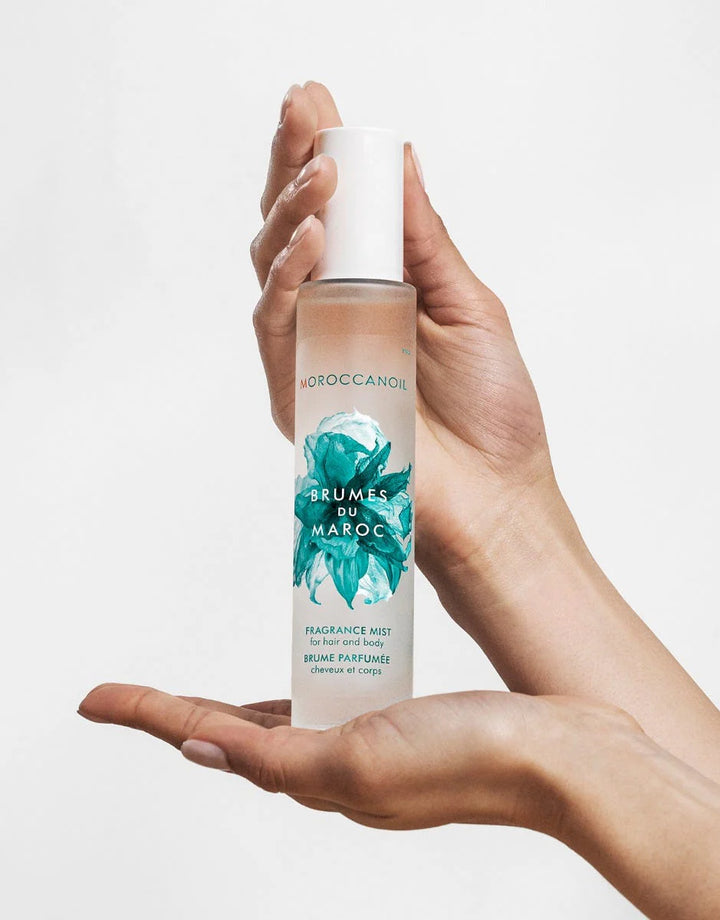 Moroccanoil Hair and Body Fragrance Mist image of model holding bottle