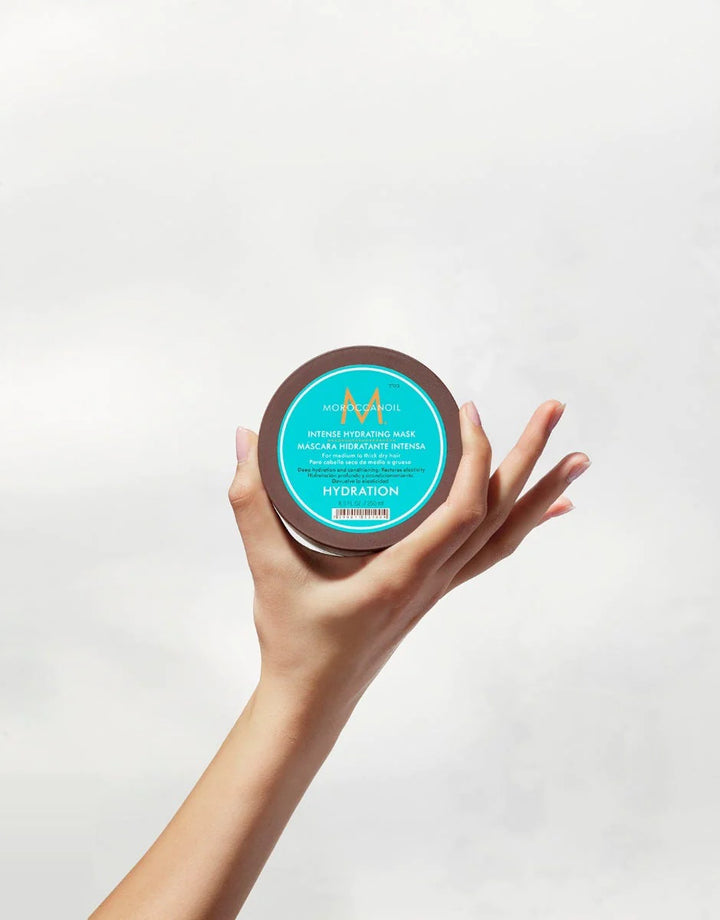 Moroccanoil Intense Hydrating Mask image of model holding jar