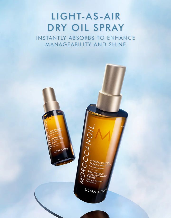Moroccanoil Ultra-Light dry oil spray bottles on a light blue background